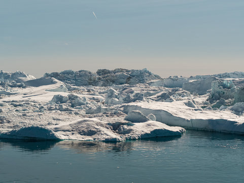 Global warming -Greenland Iceberg landscape of Ilulissat icefjord with giant icebergs. Icebergs from melting glacier. Arctic nature heavily affected by climate change