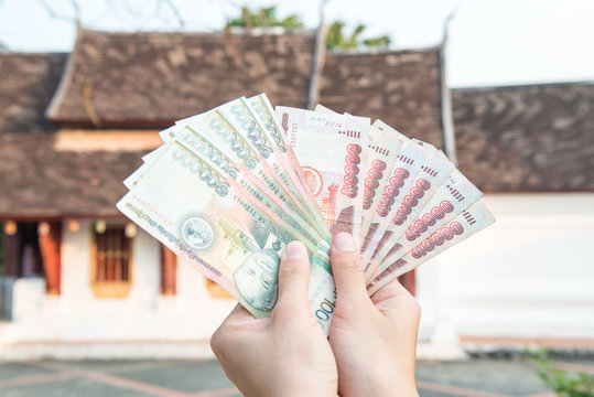 Cropped shot view of someone holding banknotes of Laos kip money the national currency of Laos.