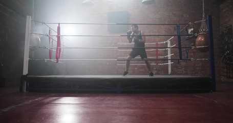 Adult male boxer shadowboxing