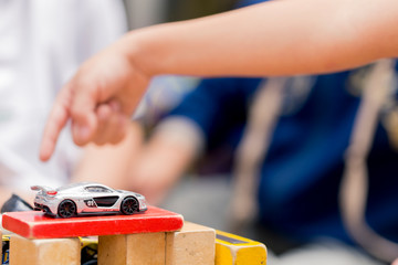 Toy car on a wooden red block