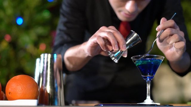 Professional asian male bartender prepare mixing cocktail drink at village night party celebration, Extra work job service customer outdoor, Slow motion