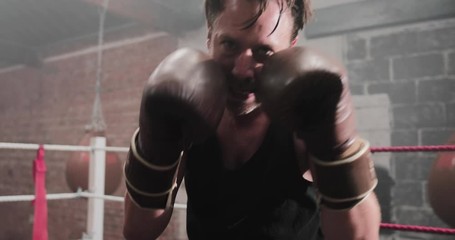 Male boxer punching to camera