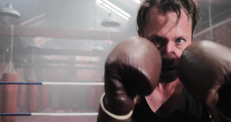 Male boxer punching to camera