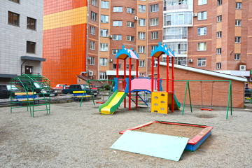 Fototapeta na wymiar Children's playground in the courtyard of the apartment building. Russia. Siberia. Summer