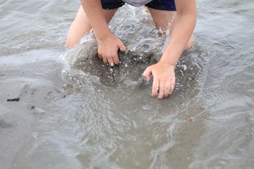 Young person playing on the sandy beach 