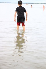 boy walking on the beach