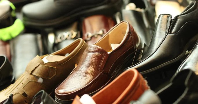 Leather shoes piled up. Stylish premium designs are showcased in a high qulaity high fasion way. Camera rotates around shot in 4k slowmotion.mov