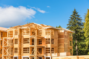 Apartment building under construction with two timber trunks on side