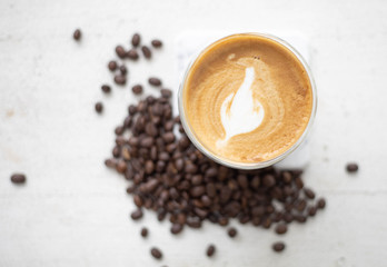 Coffee and coffee beans On the white table