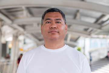 fat old asian man in city environment
