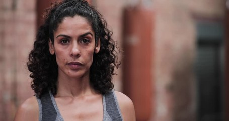 Portrait of strong mixed race female in boxing gym