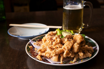 Japanese fried squid with cold beer on the table in the restaurant