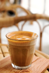 Hot latte and art latte in a glass on the table