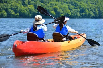 夏の湖畔・カヌーを楽しむファミリー