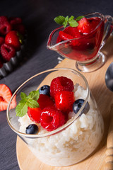delicious milk rice with different berries and red fruit jelly