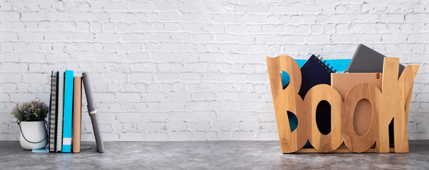 book shelf with books in wooden box on brick wall texture background.