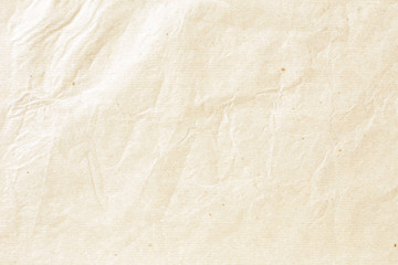 Old pale brown crumpled paper background texture