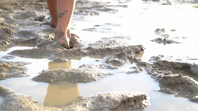 Boy walking on mud in the lake ,drought crisis from the global warming concept.