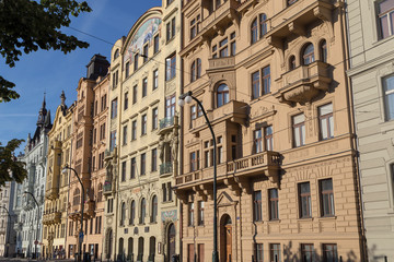 Fototapeta na wymiar View of old residential buildings along the Rasinovo nabr. street in Prague, Czech Republic, on a sunny day.
