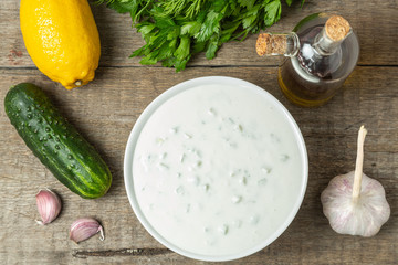 Tzatziki sauce made of yogurt, cucumbers, garlic and olive oil. National Greek cuisine. The view from the top. Copy space.