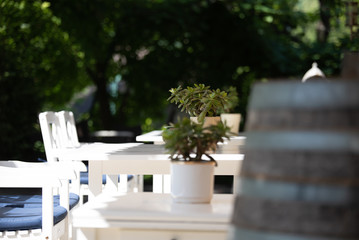 outdoor patio furniture at a cafe, Patio furniture in white. dining on a patio while on vacation