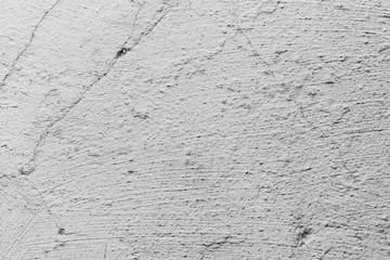 Texture of a concrete wall with cracks and scratches which can be used as a background