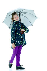 Little girl under an umbrella.