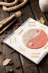 Fresh shrimp and beef paste with the shape of tai ji in a white ceramic dish