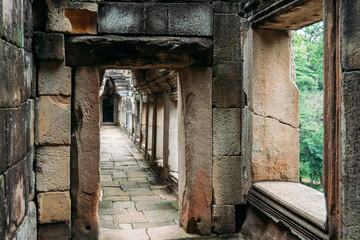 Fototapeta na wymiar Corridor made of rustic rocks in one of the temples in Angkor, Siem Reap, Cambodia