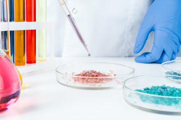 Chemical research in Petri dishes done by a scientist close up