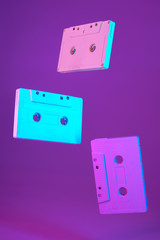 Cassette tape vintage style suspended in air on purple background