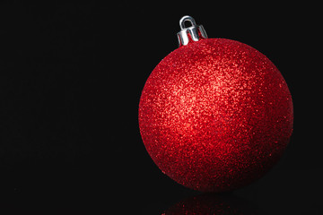 Beautiful christmas bauble close up on a dark red background