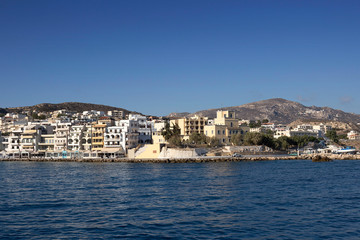 Obraz premium Karpathos island - The seafront of Pigadia village in summer day, Aegean sea, Dodecanese Islands, Greece