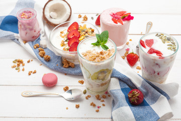 Composition with healthy food. Strawberries and yoghurt breakfast on table