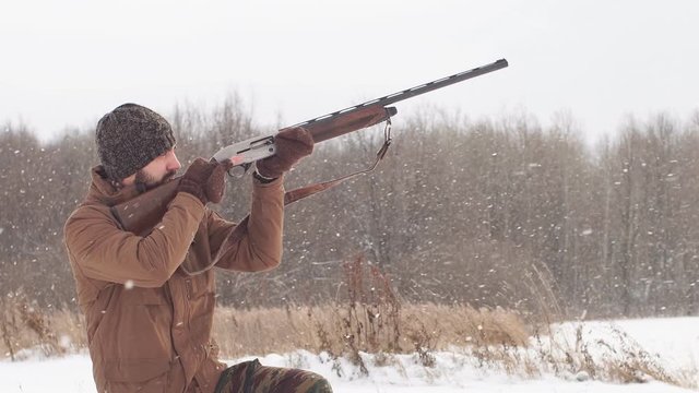 Young hunter pointed his weapon at the bird. Bird hunting concept