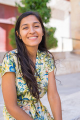 Young indian woman laughing in the street