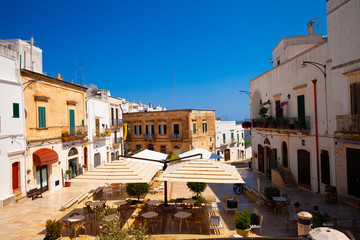 Ostuni, Italy - 12.08.19: old town with restaurants Ostuni is known as the white town.