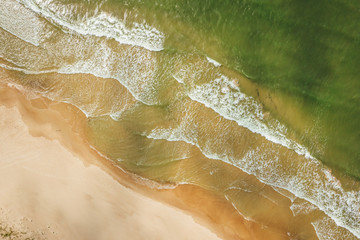 Fototapeta na wymiar Aerial view of beach, sea waves and sand on baltic coast beach, nature background