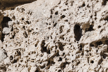 Detail of white stone with holes