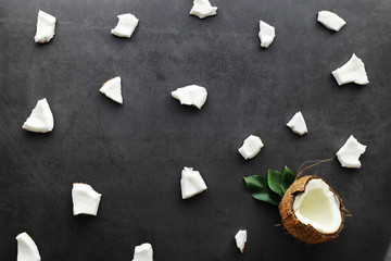 Coconut on a dark stone table. Coconut oil.