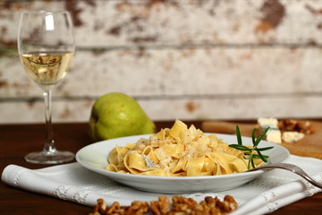 Pappardelle al Gorgonzola. Pasta (Fettuccine) with gorgonzola, pear, walnuts and white wine.