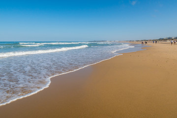 Fototapeta na wymiar La Barrosa beach, in Sancti Petri, Cadiz, when the tide is low and there is a lot of sand.