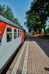 Fototapeta na wymiar Children's narrow-gauge railway train preparing for departure. Novomoskovsk, Tula, Russia
