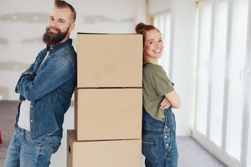 Proud pleased young couple moving into a new home