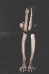 Naklejka premium Depression or domestic violence Concept, Desaturated grunge image of a very sad adult woman crying