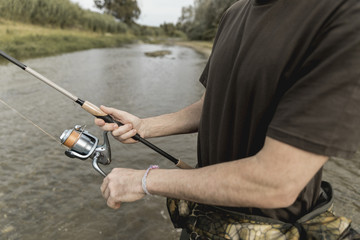 Naklejka premium Man fishing at the river