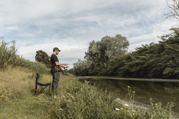 Obraz na płótnie Canvas Man fishing at the river