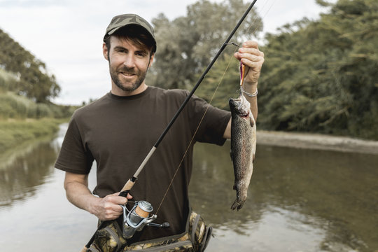 Person fishing a fish with a rod