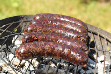 Grilling Blood Sausages on barbecue grill
