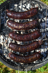 Grilling Blood Sausages on barbecue grill